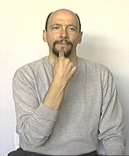 start of 'I tell you'. In a human picture, dominant hand's index finger extended and near mouth.